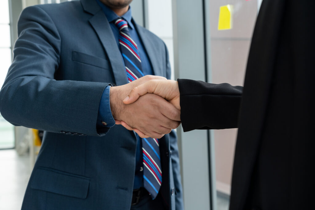 A sales rep shaking hands with a long-term customer
